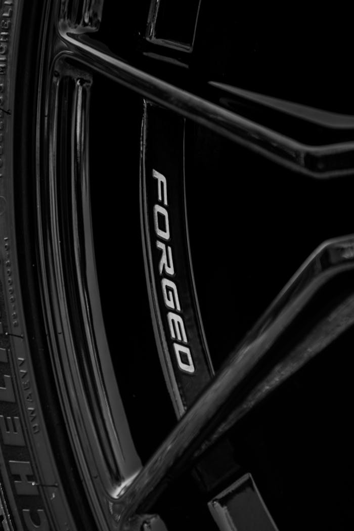 Close-up of a black forged alloy wheel with sleek design elements.